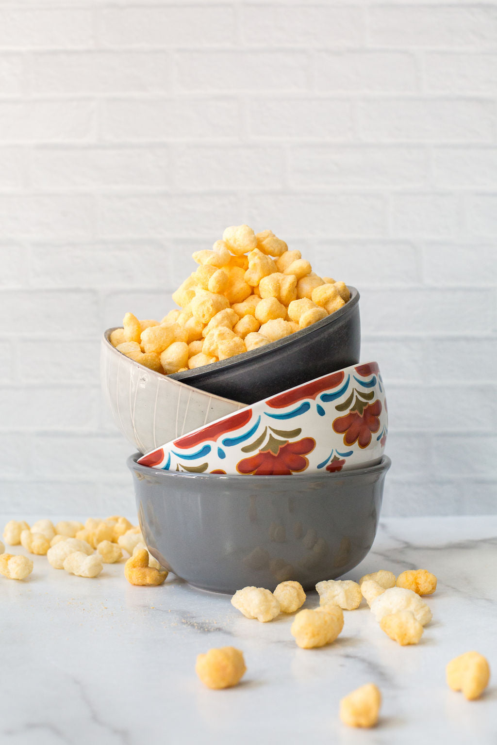 Ancient Grain Pops spilling out of bowls on countertop
