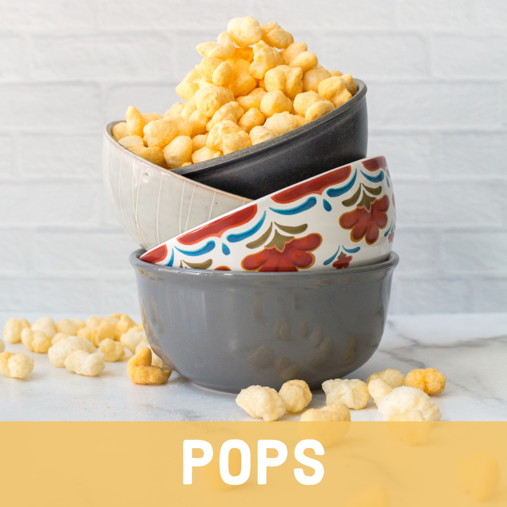 Stack of bowls on counter spilling over with Ancient Grain Pops with Headline of Pops at bottom